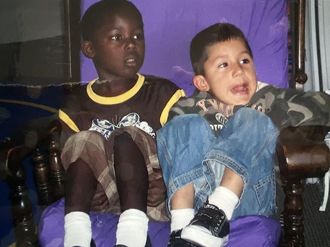 Two boys sitting in a rocking chair